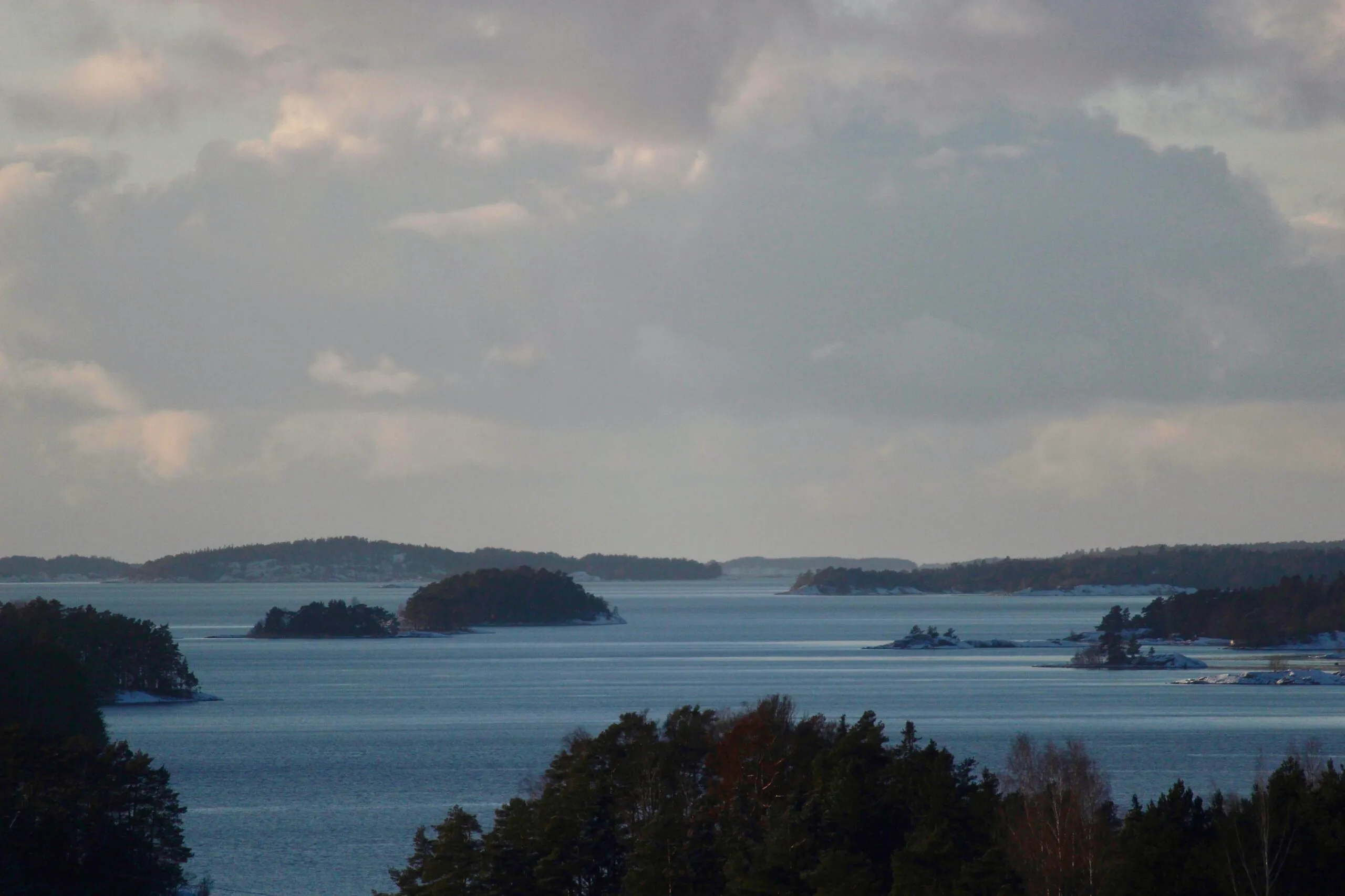 Angler casting from a boat at dusk in the archipelago
